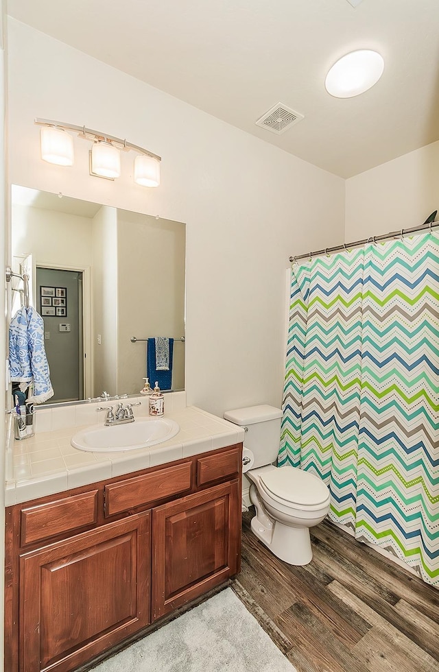 bathroom with vanity, wood-type flooring, and toilet