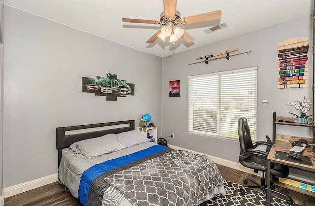 bedroom with ceiling fan and dark hardwood / wood-style floors