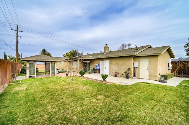 back of property with a patio and a lawn