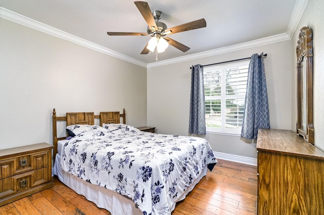 bedroom with hardwood / wood-style floors, crown molding, and ceiling fan