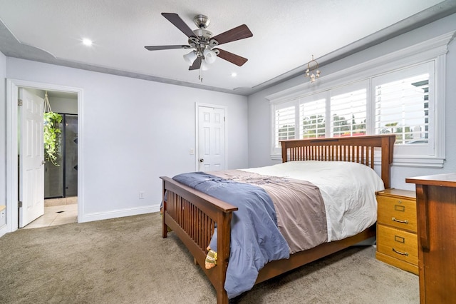 carpeted bedroom featuring ceiling fan and ensuite bath