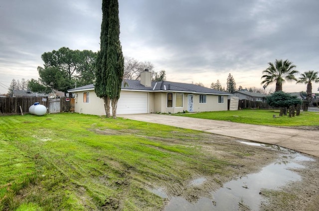 view of front of home featuring a garage and a front lawn