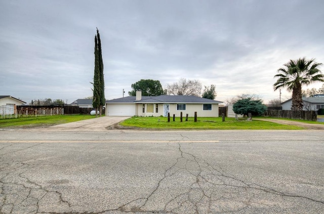 single story home with a garage and a front yard