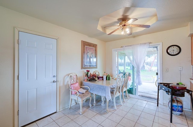 tiled dining area with ceiling fan