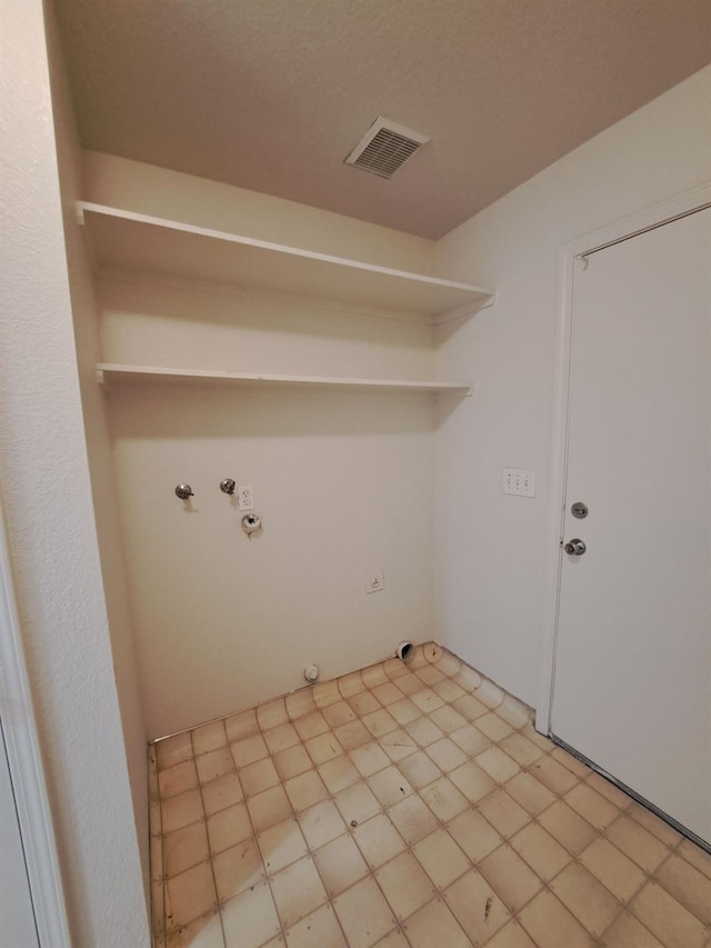 washroom with laundry area, hookup for a gas dryer, and visible vents