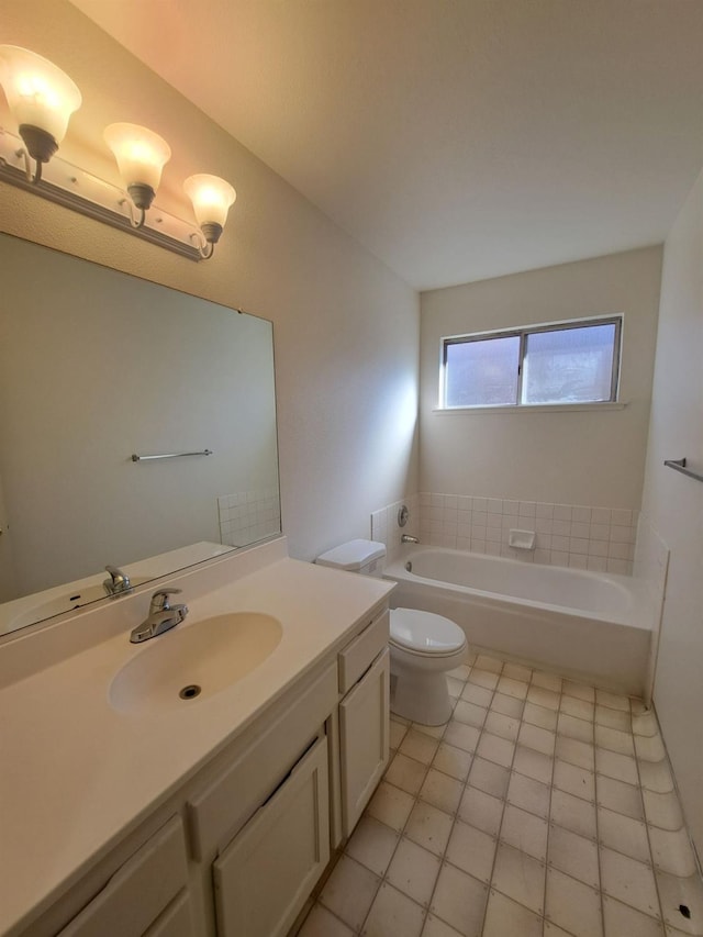 bathroom featuring toilet, a bath, and vanity