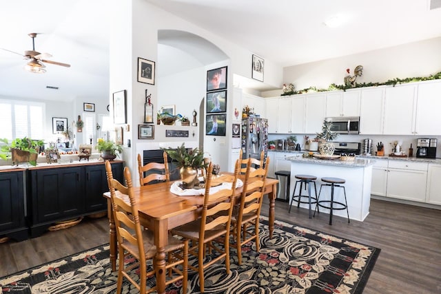 dining space with dark hardwood / wood-style flooring and ceiling fan