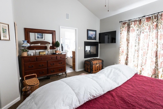 carpeted bedroom with lofted ceiling and connected bathroom