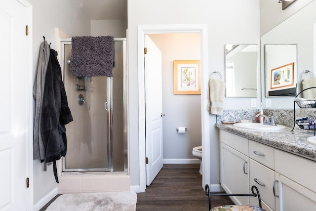 bathroom with vanity, hardwood / wood-style floors, toilet, and walk in shower