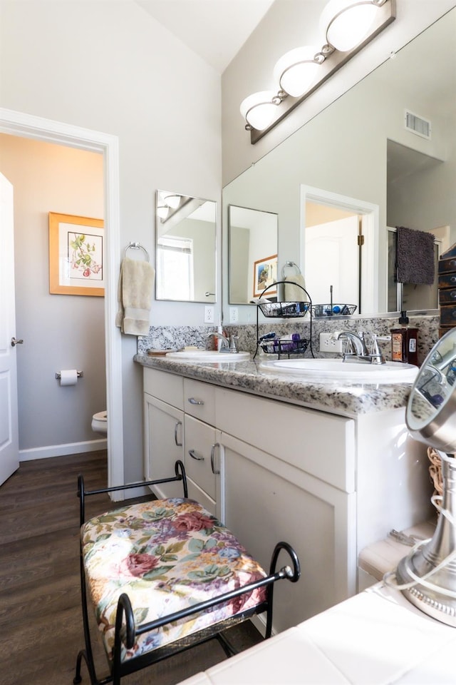 bathroom with vanity, hardwood / wood-style floors, and toilet