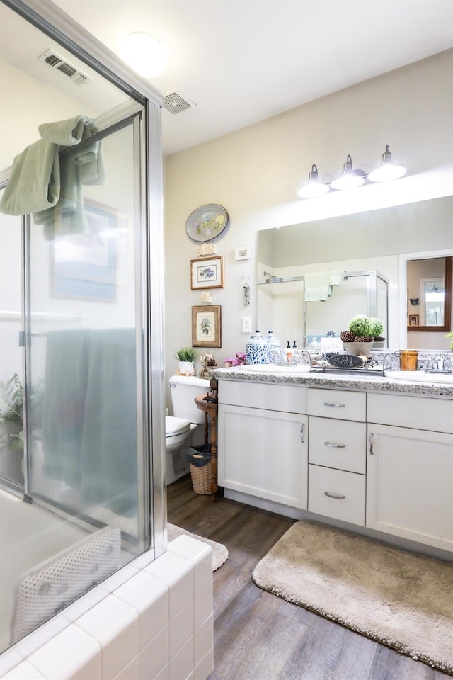 bathroom featuring hardwood / wood-style flooring, vanity, and toilet