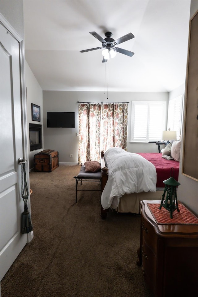 bedroom featuring vaulted ceiling, ceiling fan, and dark carpet