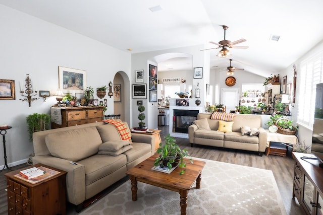 living room featuring vaulted ceiling, hardwood / wood-style floors, and a wealth of natural light