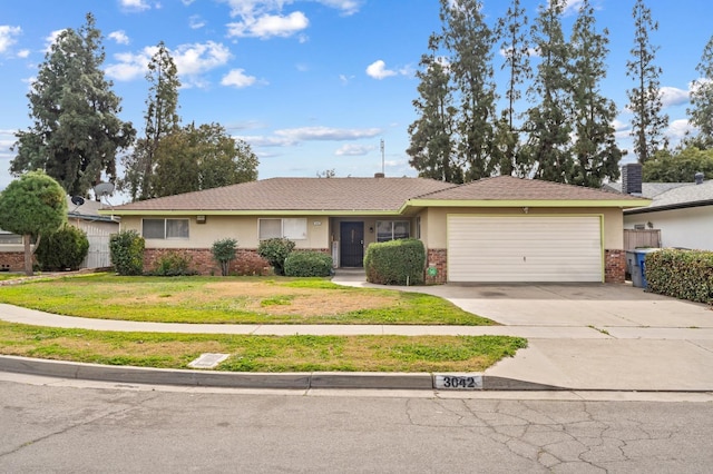 single story home featuring a garage and a front yard