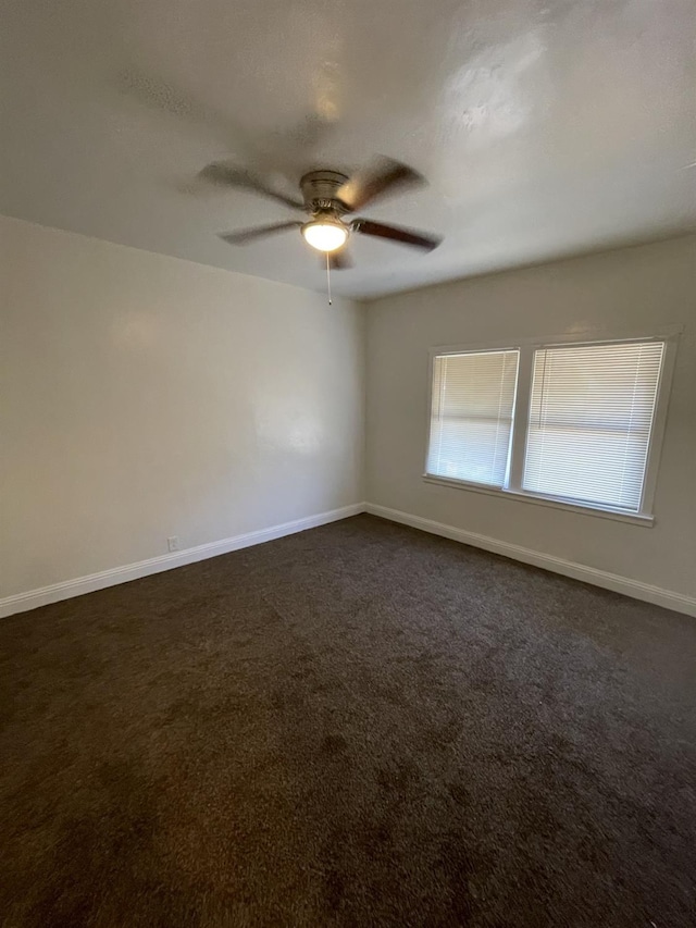 3185 W Mckinley, Fresno, CA 93722 - empty room with ceiling fan, baseboards, and dark colored carpet