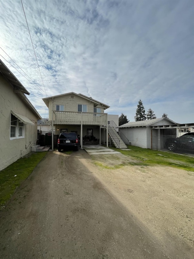 3185 W Mckinley, Fresno, CA 93722 - raised beach house with aphalt driveway and stairway