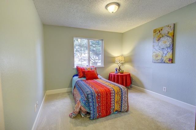 carpeted bedroom featuring a textured ceiling