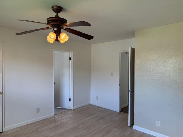 unfurnished room featuring ceiling fan and light hardwood / wood-style flooring