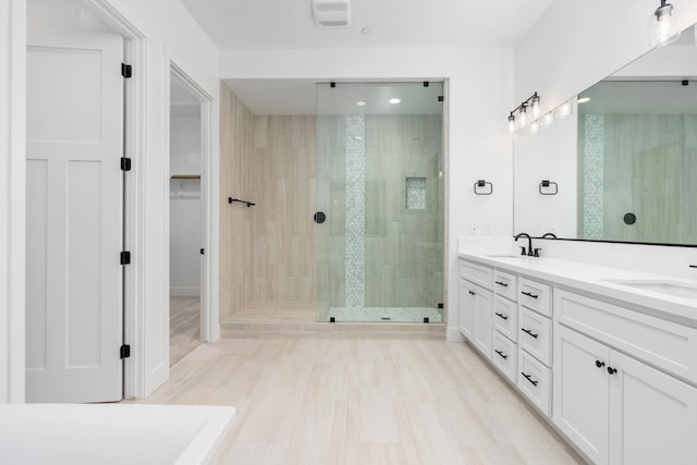 bathroom featuring vanity and tiled shower