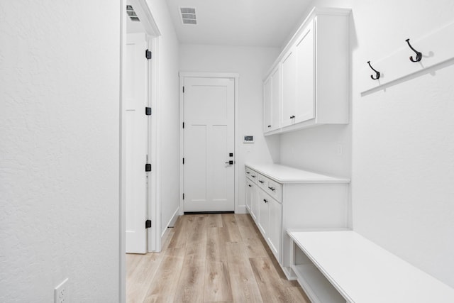 mudroom with light hardwood / wood-style flooring