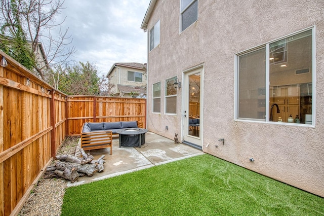 view of yard with an outdoor living space with a fire pit and a patio area