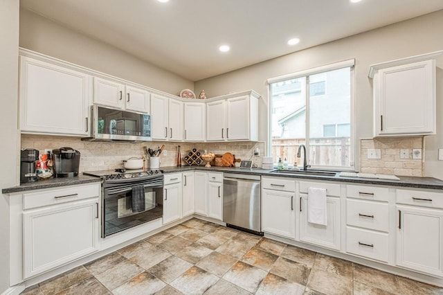 kitchen featuring appliances with stainless steel finishes, sink, and white cabinets