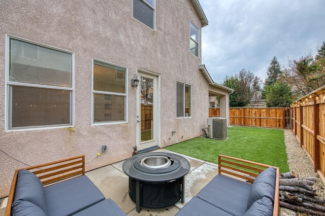 view of patio featuring cooling unit and an outdoor living space with a fire pit