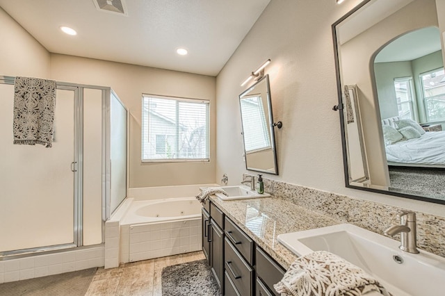 bathroom featuring vanity and plus walk in shower