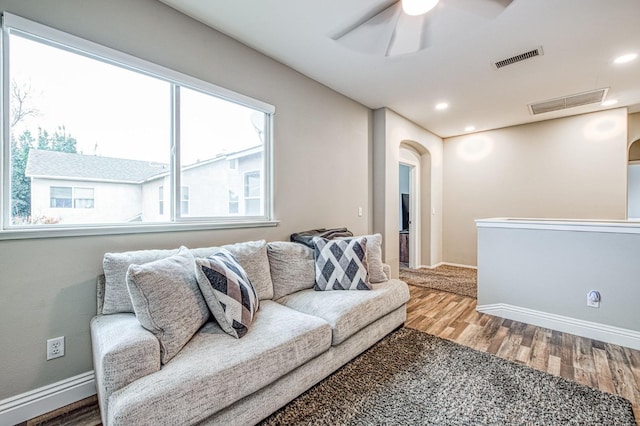 living room with hardwood / wood-style flooring and ceiling fan