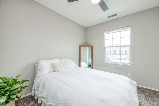 bedroom with ceiling fan, carpet flooring, and vaulted ceiling