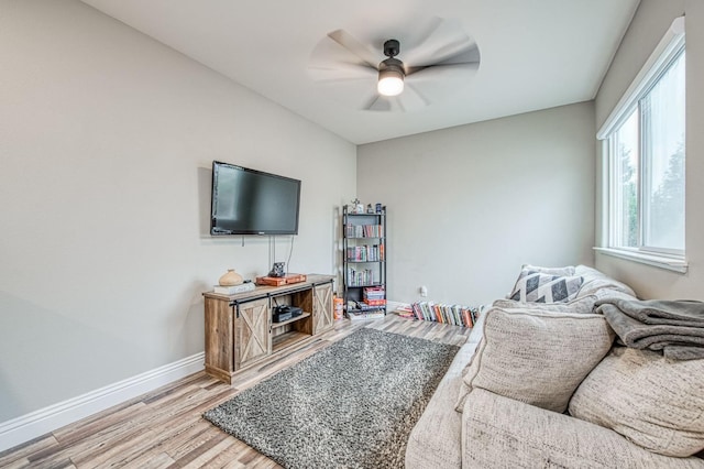 living room featuring hardwood / wood-style flooring and ceiling fan