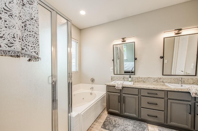 bathroom featuring vanity, tile patterned flooring, and separate shower and tub