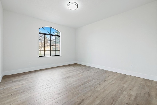 spare room featuring light wood-type flooring