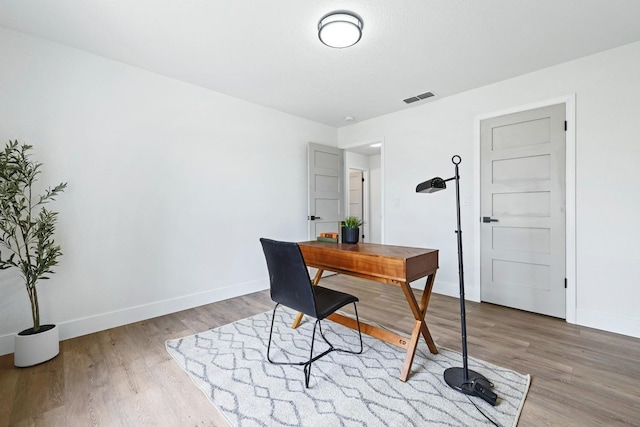 home office with wood-type flooring