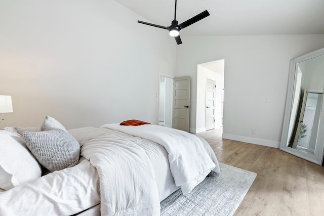 bedroom with high vaulted ceiling, ceiling fan, and light wood-type flooring