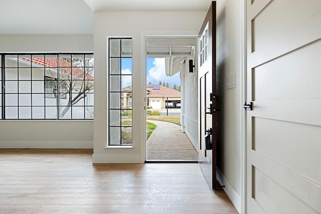 5017 W Locust Ave, Fresno, CA 93722 - doorway to outside featuring plenty of natural light and light wood-style flooring
