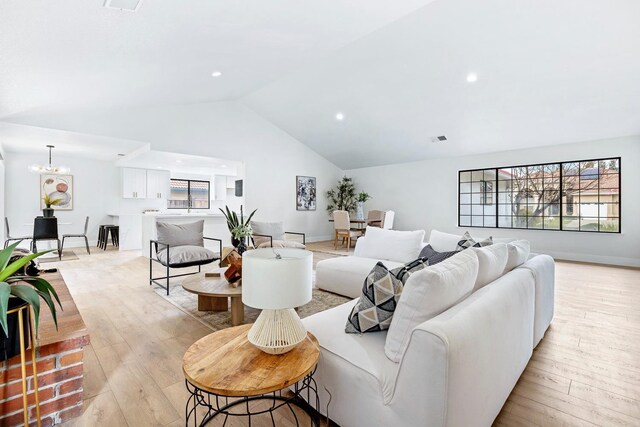 5017 W Locust Ave, Fresno, CA 93722 - living area with lofted ceiling, light wood-type flooring, a chandelier, and recessed lighting