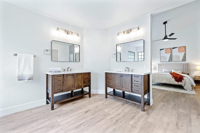 bathroom with hardwood / wood-style flooring, vanity, and ceiling fan