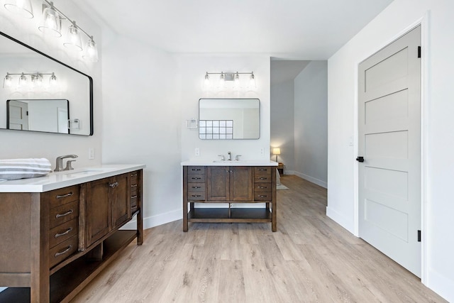 5017 W Locust Ave, Fresno, CA 93722 - bathroom with wood finished floors, two vanities, and rail lighting