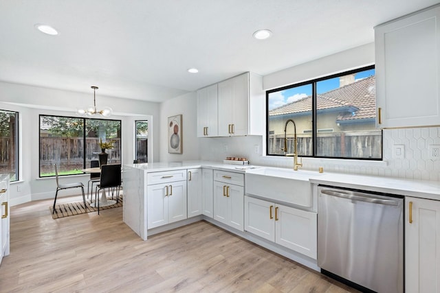 5017 W Locust Ave, Fresno, CA 93722 - kitchen featuring dishwasher, a peninsula, plenty of natural light, a chandelier, and recessed lighting