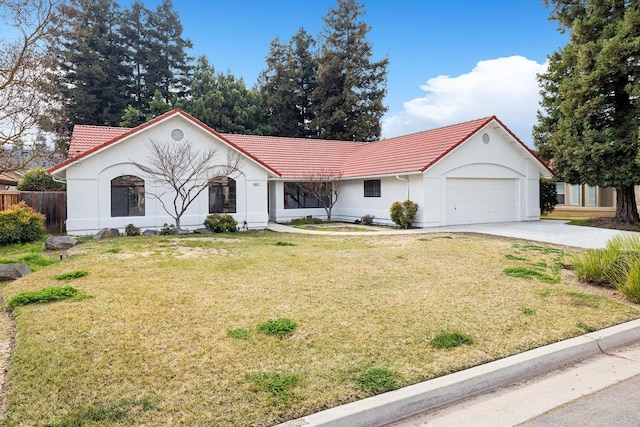 view of front of property with a garage and a front lawn