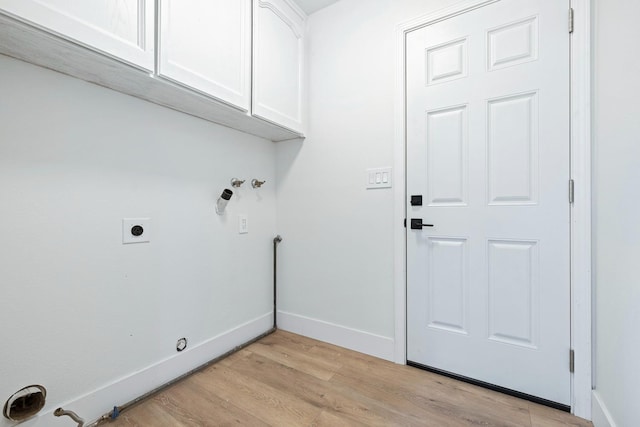 5017 W Locust Ave, Fresno, CA 93722 - laundry room featuring cabinet space, light wood-style floors, and hookup for an electric dryer