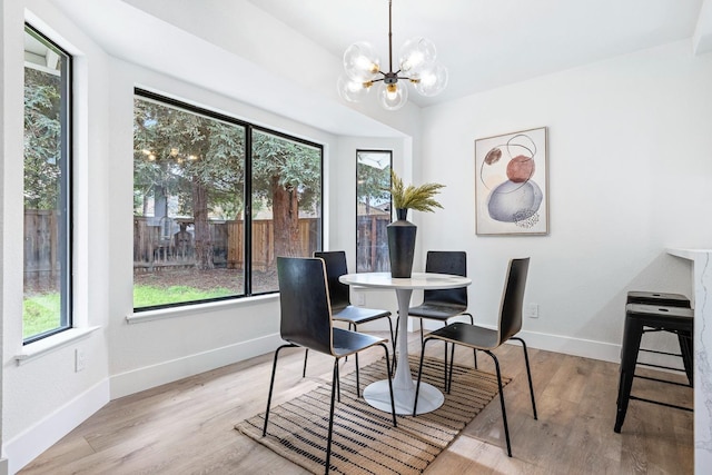 dining space featuring a chandelier and light wood-type flooring