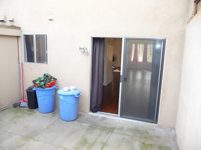 view of exterior entry with a patio