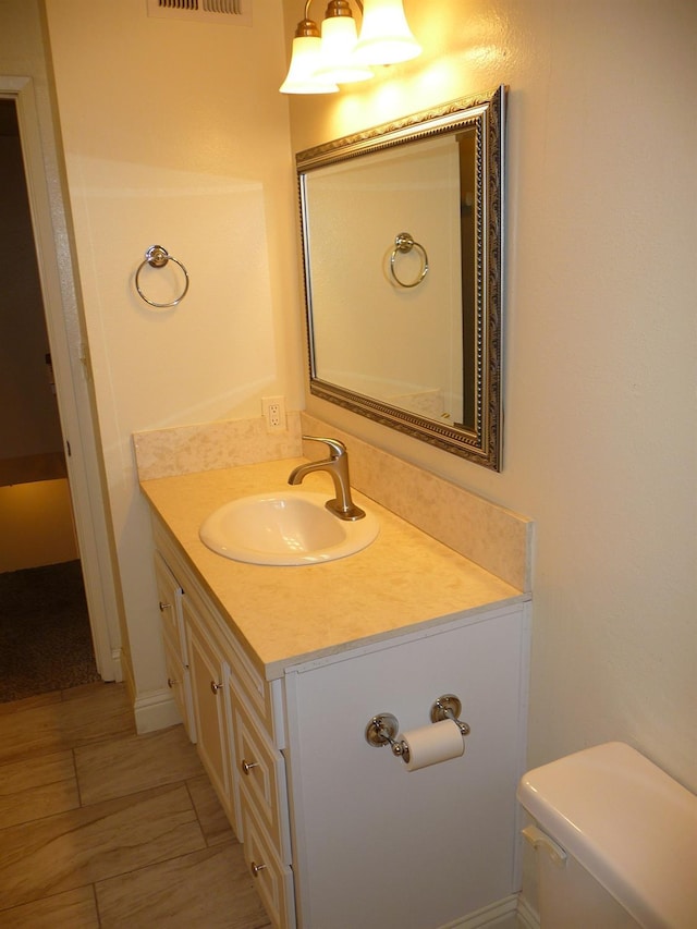 bathroom featuring vanity and toilet