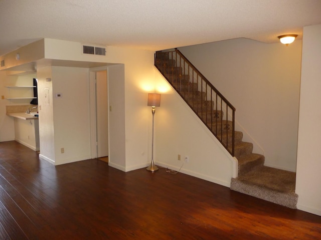 unfurnished living room featuring dark hardwood / wood-style floors