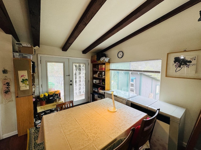 dining space featuring vaulted ceiling with beams and french doors