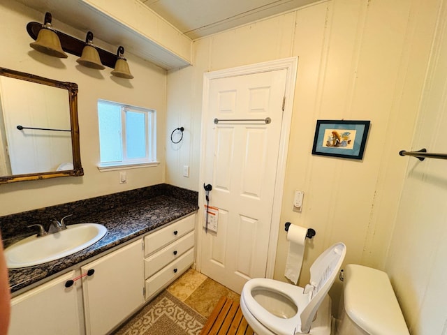 bathroom with vanity, toilet, and tile patterned flooring