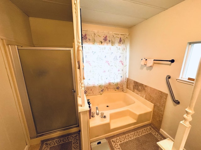 bathroom with a wealth of natural light and separate shower and tub