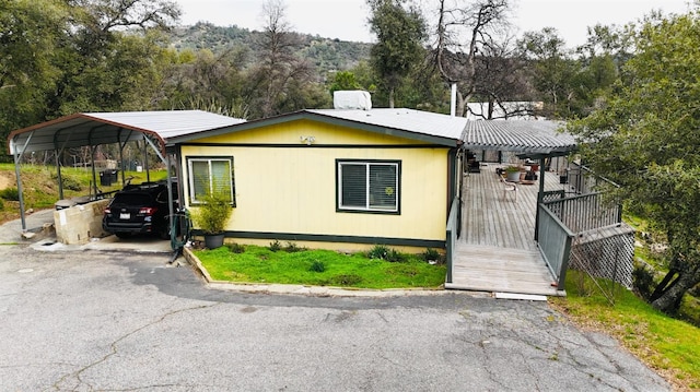 view of front facade featuring a carport and a deck